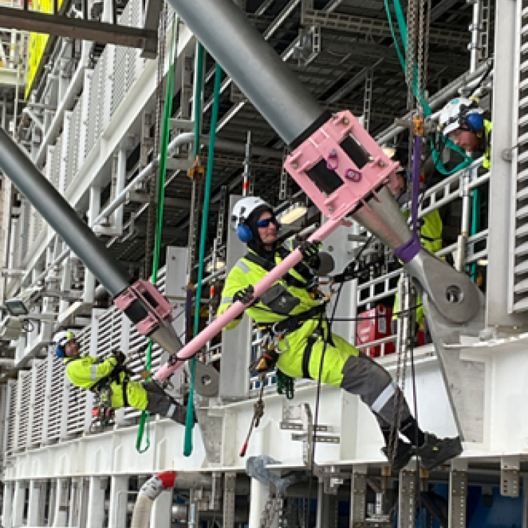 workers installing balcony struts